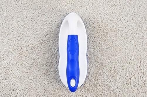 Scrubbing brush with ergonomic curved handle for carpet cleaning